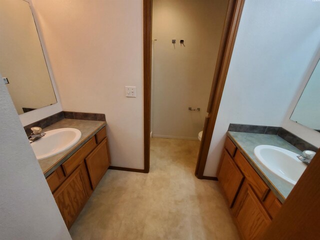 1135-1137 NE Indiana St, Pullman, WA 99163 - bathroom with toilet, two vanities, and a sink