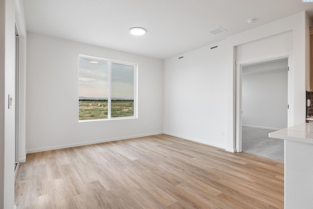 unfurnished room featuring light hardwood / wood-style floors