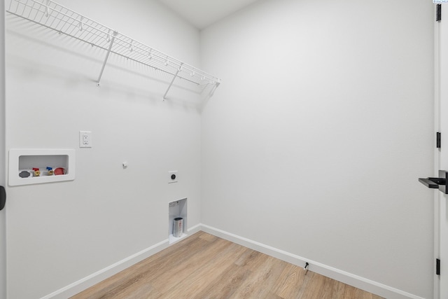 laundry room featuring hardwood / wood-style flooring, washer hookup, hookup for an electric dryer, and gas dryer hookup