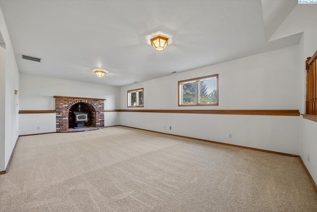 1110 W 22nd Ave, Kennewick, WA 99337 - unfurnished living room featuring carpet floors, baseboards, and a wood stove