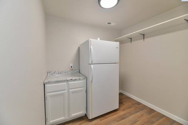 745 SE Carolstar Dr, Pullman, WA 99163 - kitchen featuring freestanding refrigerator, open shelves, light wood-style flooring, white cabinetry, and baseboards