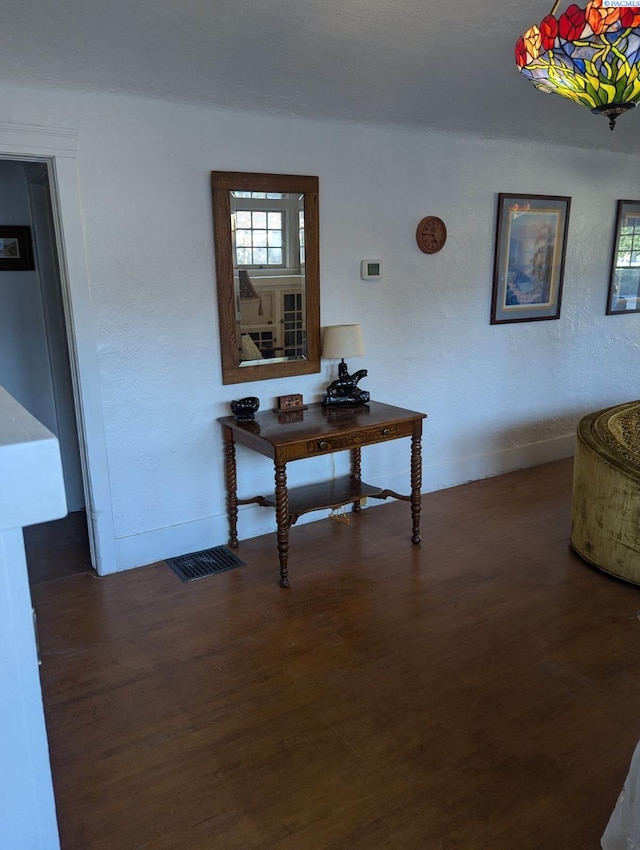 corridor with dark hardwood / wood-style flooring