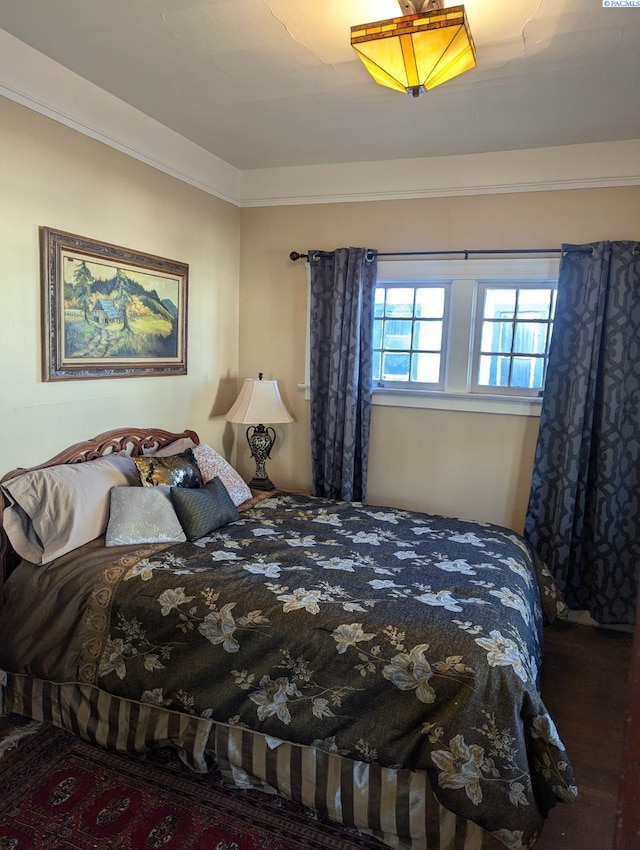 bedroom featuring crown molding and hardwood / wood-style floors