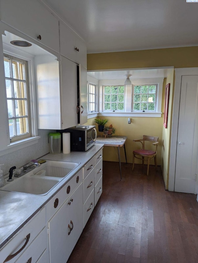 kitchen with a healthy amount of sunlight, sink, and white cabinets