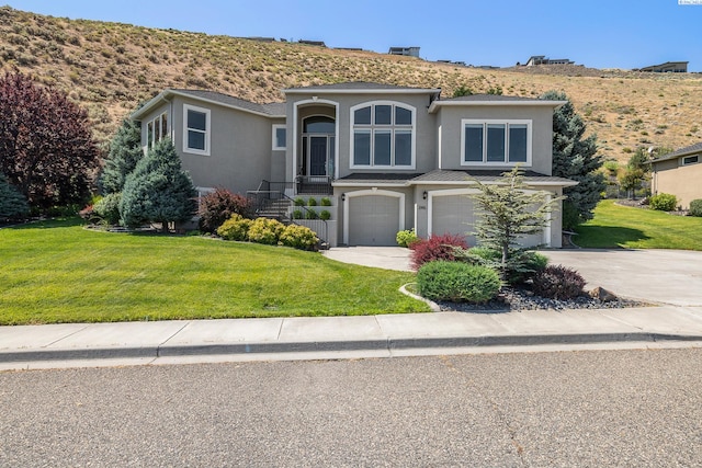 view of front of home with a garage and a front lawn