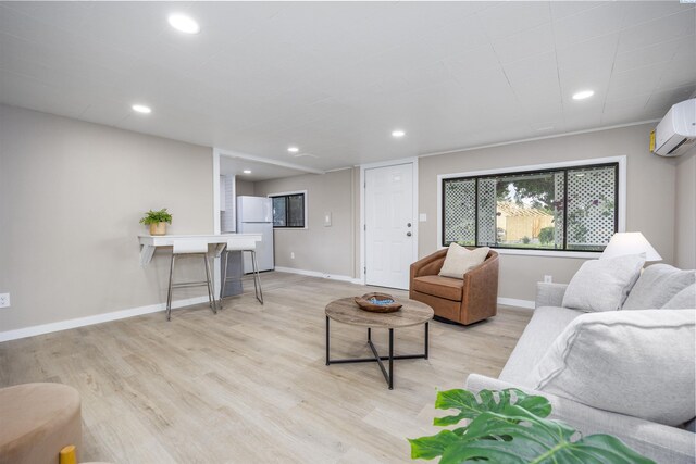 1517 Perkins Ave, Richland, WA 99354 - living room featuring a wall mounted AC, light wood-style floors, baseboards, and recessed lighting