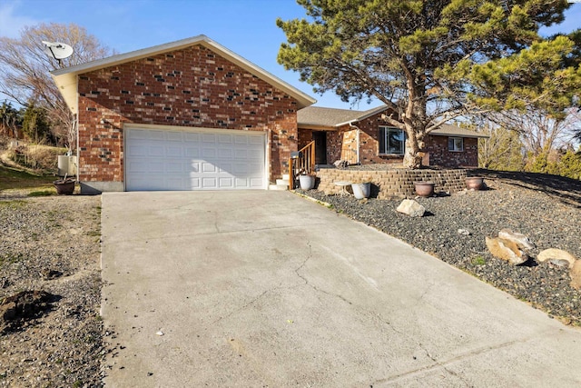 ranch-style house with driveway, an attached garage, and brick siding