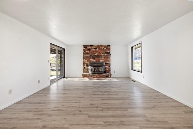 unfurnished living room with baseboards and wood finished floors