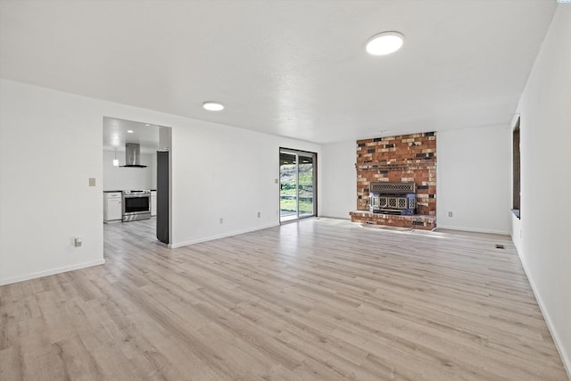 unfurnished living room featuring light wood-style floors and baseboards