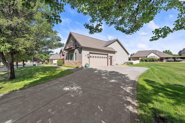 19 Ivy Ln, Pasco, WA 99301 - view of front of home featuring a front yard, concrete driveway, stone siding, and an attached garage