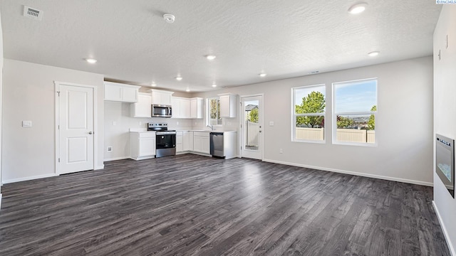 592 S Zeelar St, Kennewick, WA 99336 - unfurnished living room with dark wood finished floors, a textured ceiling, and recessed lighting