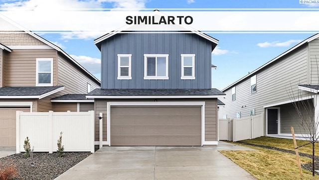 592 S Zeelar St, Kennewick, WA 99336 - view of front of property with board and batten siding, an attached garage, and driveway