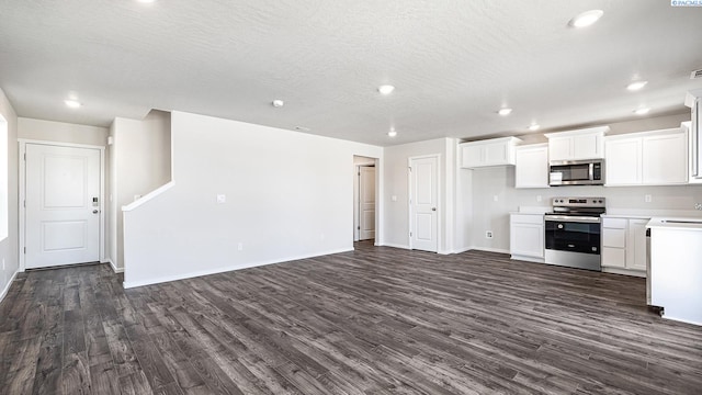 592 S Zeelar St, Kennewick, WA 99336 - kitchen with stainless steel appliances, dark wood-style floors, light countertops, open floor plan, and white cabinetry