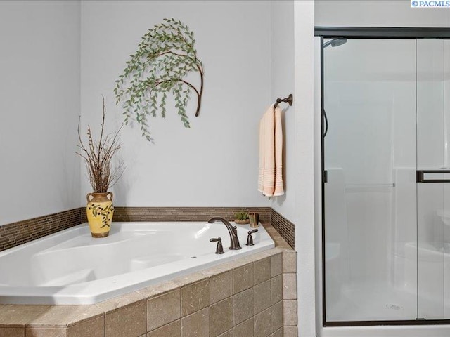 bathroom with a garden tub and a stall shower