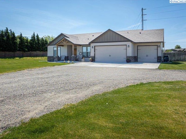 82647 E Reata Rd, Kennewick, WA 99338 - ranch-style house with concrete driveway, a garage, board and batten siding, and roof with shingles