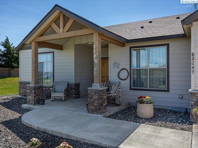 exterior space featuring a patio and stone siding