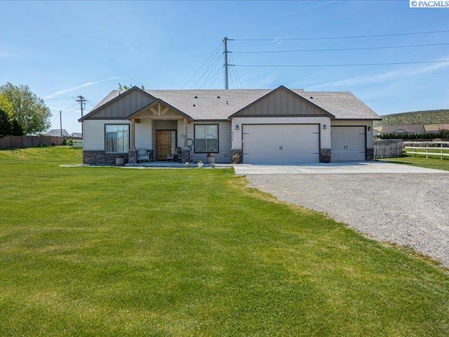 single story home with a garage, a front lawn, fence, board and batten siding, and driveway