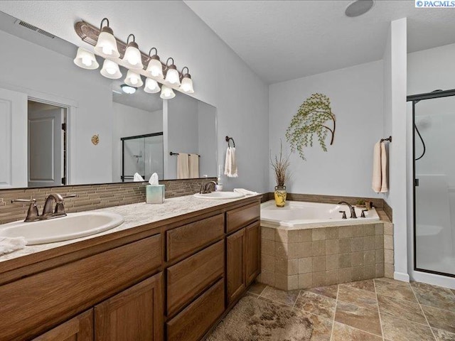 full bath with a garden tub, a sink, double vanity, and a shower stall
