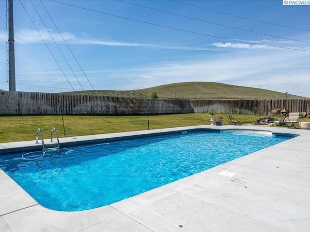 view of swimming pool with a fenced backyard, a fenced in pool, a yard, and a patio