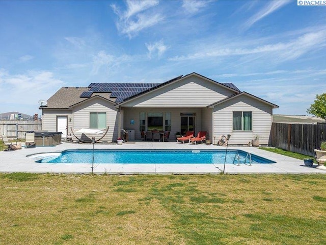 exterior space featuring a lawn, a fenced backyard, and a hot tub