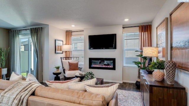 611 S Zeelar St, Kennewick, WA 99336 - living area featuring wood finished floors, a glass covered fireplace, and recessed lighting