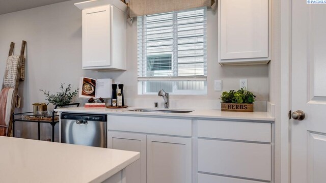 611 S Zeelar St, Kennewick, WA 99336 - kitchen with stainless steel dishwasher, light countertops, and white cabinetry