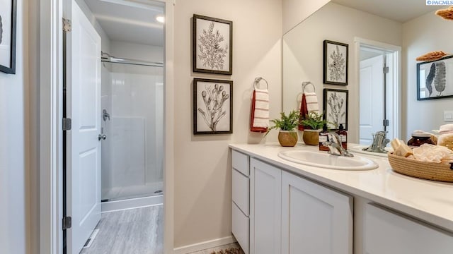 611 S Zeelar St, Kennewick, WA 99336 - full bathroom featuring a stall shower, vanity, and wood finished floors