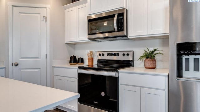 611 S Zeelar St, Kennewick, WA 99336 - kitchen featuring appliances with stainless steel finishes, light countertops, and white cabinetry