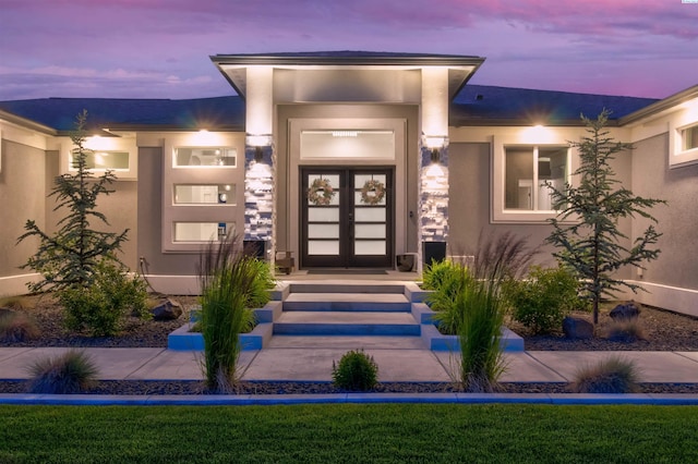 exterior entry at dusk with french doors