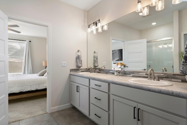 bathroom with connected bathroom, tile patterned flooring, a sink, and double vanity