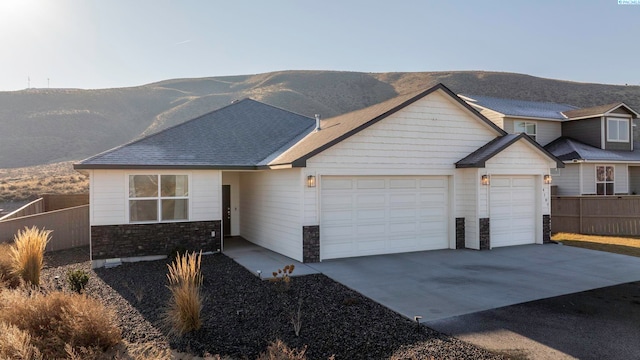 view of front of home featuring a mountain view and a garage