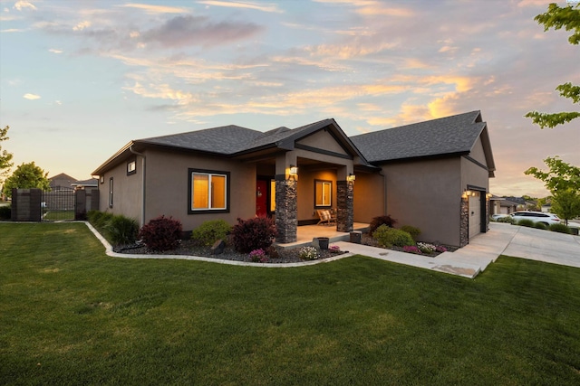 1120 S Kansas Pl, Kennewick, WA 99338 - prairie-style home featuring a garage, a gate, a front yard, and stucco siding