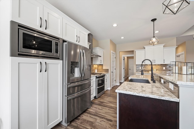 1120 S Kansas Pl, Kennewick, WA 99338 - kitchen featuring dark wood-style floors, white cabinetry, a sink, appliances with stainless steel finishes, and backsplash