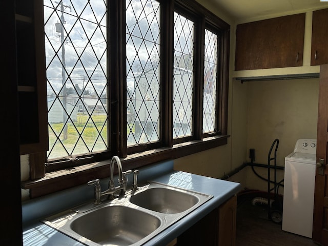 kitchen with washer / clothes dryer and sink