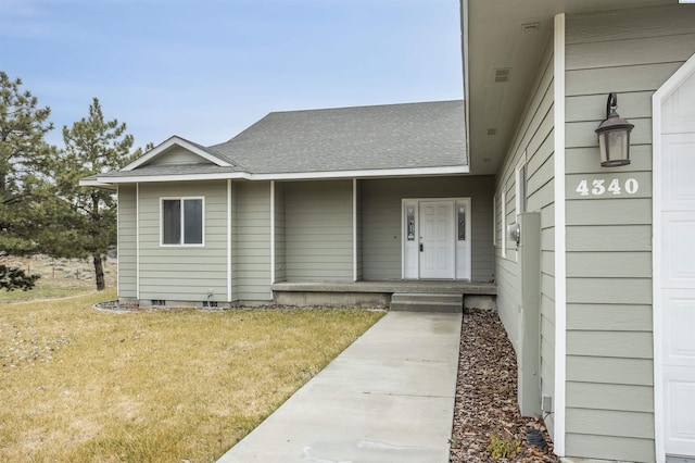 doorway to property featuring a yard