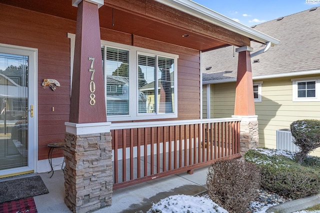 entrance to property with central AC unit and a porch