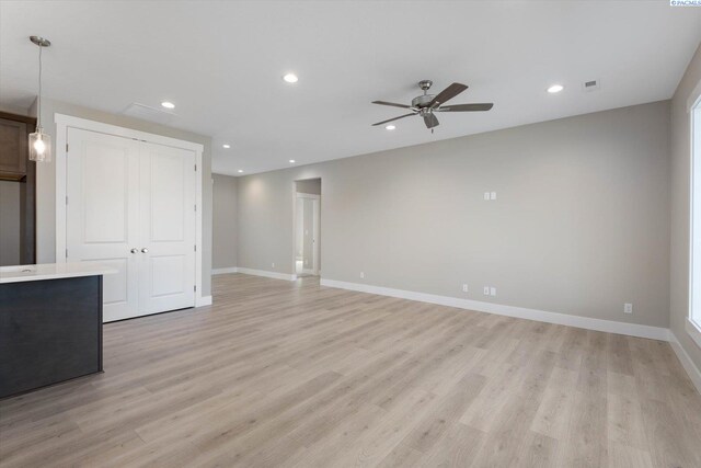 unfurnished living room featuring ceiling fan and light hardwood / wood-style floors