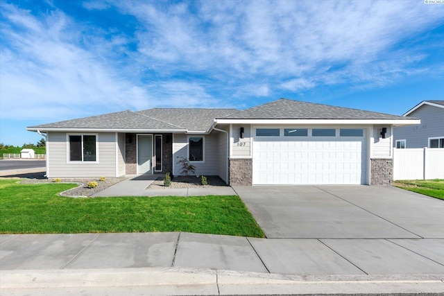 ranch-style house with a garage and a front lawn