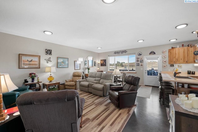 living room featuring concrete flooring and recessed lighting