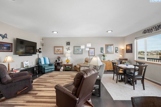 living area featuring baseboards and recessed lighting