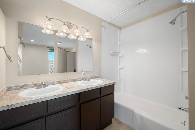 bathroom with a textured ceiling, shower / bathing tub combination, and a sink