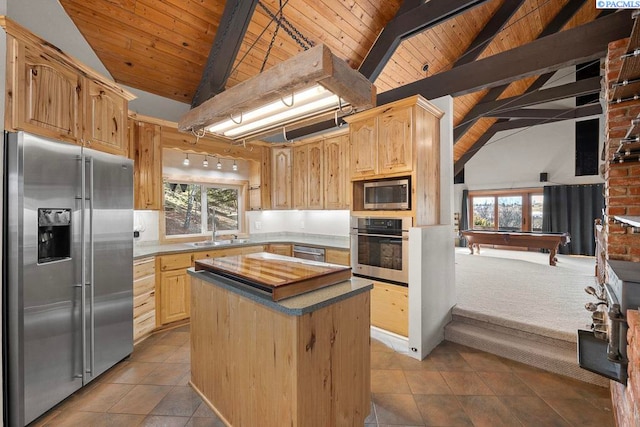 kitchen featuring a wealth of natural light, appliances with stainless steel finishes, a sink, and light brown cabinetry