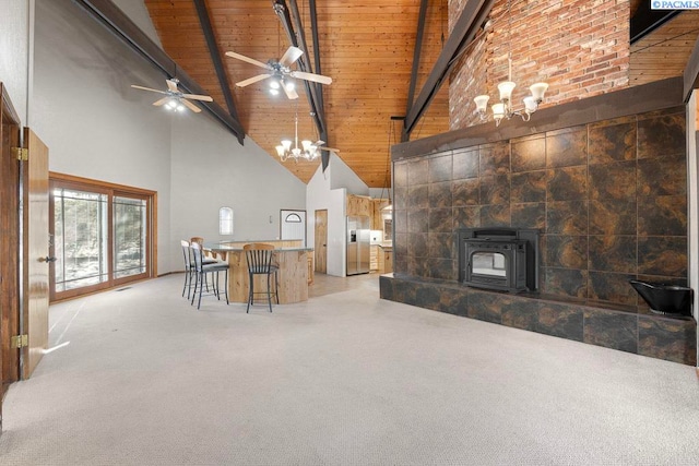 unfurnished living room with light carpet, high vaulted ceiling, wooden ceiling, beamed ceiling, and ceiling fan with notable chandelier