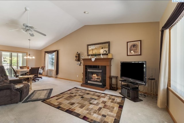 704 W 18th Ct, Kennewick, WA 99337 - living area with carpet flooring, vaulted ceiling, a ceiling fan, a tiled fireplace, and baseboards