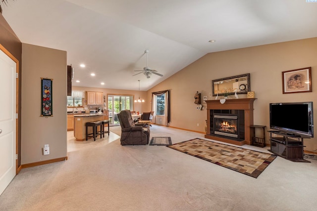 704 W 18th Ct, Kennewick, WA 99337 - living area with light carpet, vaulted ceiling, ceiling fan, baseboards, and a glass covered fireplace