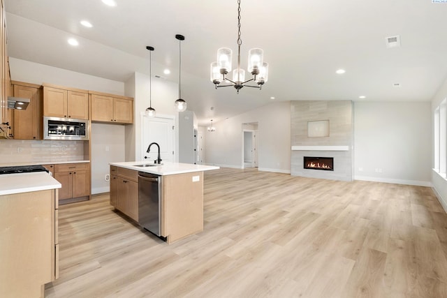 10709 Kokanee Dr, Pasco, WA 99301 - kitchen featuring appliances with stainless steel finishes, lofted ceiling, tasteful backsplash, recessed lighting, and light countertops