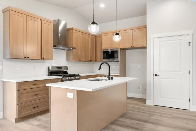 10709 Kokanee Dr, Pasco, WA 99301 - kitchen with stainless steel appliances, wall chimney range hood, tasteful backsplash, light wood finished floors, and vaulted ceiling