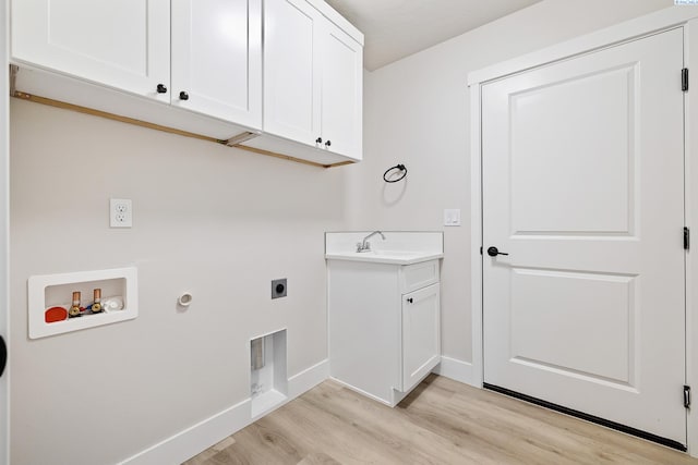 10709 Kokanee Dr, Pasco, WA 99301 - washroom with hookup for an electric dryer, cabinet space, light wood-style floors, washer hookup, and hookup for a gas dryer