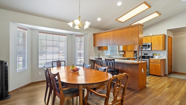 4318 Desert Pl, Pasco, WA 99301 - dining space with light wood-style floors, a chandelier, vaulted ceiling, and recessed lighting
