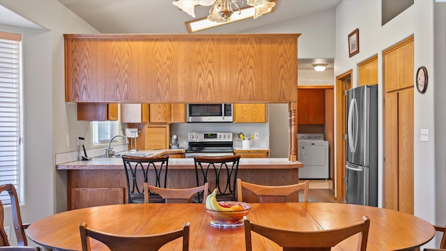 4318 Desert Pl, Pasco, WA 99301 - dining area featuring washer / clothes dryer, lofted ceiling, and a chandelier
